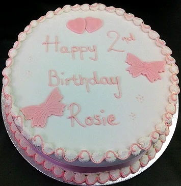 Round celebration cake finished with pale pink icing