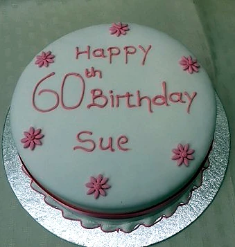 Round celebration cake with pink floral icing