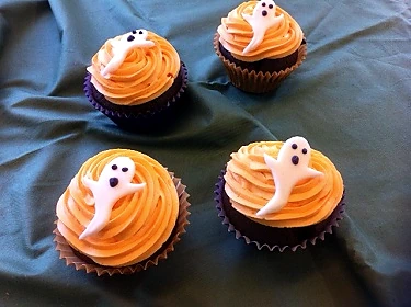 Halloween cupcakes topped with little white ghost decorations